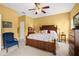 Well-lit bedroom with carpet, large wooden furniture, and a ceiling fan at 118 Ventana Dr, Kissimmee, FL 34759