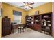 Bright office with a large bookcase, a desk, and a comfortable chair at 118 Ventana Dr, Kissimmee, FL 34759