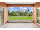 Inviting screened-in patio with tile flooring and a beautiful view of the lush, green backyard at 118 Ventana Dr, Kissimmee, FL 34759