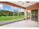 Screened-in patio with ceiling fan and view of green backyard providing a serene outdoor living space at 118 Ventana Dr, Kissimmee, FL 34759
