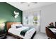 Bright bedroom with a fun accent wall, a queen bed, and windows that provide a lot of natural light at 13334 Beebe Aly, Orlando, FL 32827