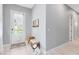 Bright foyer featuring light wood floors, gray walls, and a stylish bench with decor accents at 13334 Beebe Aly, Orlando, FL 32827