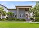 Charming two-story home with gray siding, covered porch, landscaped yard, and a red front door at 13334 Beebe Aly, Orlando, FL 32827