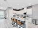Modern kitchen with white cabinets, stainless steel appliances, granite counters, and island seating at 13334 Beebe Aly, Orlando, FL 32827