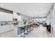 Open-concept kitchen with white cabinets, granite countertops, island seating, and modern appliances at 13334 Beebe Aly, Orlando, FL 32827