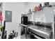 Efficient laundry room with stainless steel washer and dryer and storage shelves at 13334 Beebe Aly, Orlando, FL 32827