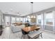 Bright living area with a modern sofa, large windows, and a view of the dining area at 13334 Beebe Aly, Orlando, FL 32827