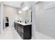 Ensuite featuring a dual sink vanity with stone countertops and large standing shower at 13334 Beebe Aly, Orlando, FL 32827