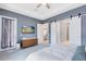 Airy primary bedroom showcasing tray ceilings, ensuite access, and exterior access to backyard at 13334 Beebe Aly, Orlando, FL 32827