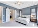 Spacious primary bedroom featuring a tray ceiling, barn door to the ensuite, and plenty of natural light at 13334 Beebe Aly, Orlando, FL 32827
