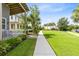 Landscaped walkway leading to the home with well-maintained lawn and views of neighboring properties at 13334 Beebe Aly, Orlando, FL 32827