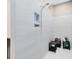 Tiled standing shower with built-in shelving, offering a convenient and luxurious bathing experience at 13334 Beebe Aly, Orlando, FL 32827
