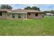 Grassy backyard featuring a sunroom addition to the home at 1335 Cr 442, Lake Panasoffkee, FL 33538