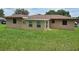 Spacious backyard with well-maintained lawn, featuring sunroom addition to house at 1335 Cr 442, Lake Panasoffkee, FL 33538