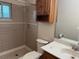 Bathroom featuring a tiled shower, a toilet, and a vanity with a sink and storage at 1335 Cr 442, Lake Panasoffkee, FL 33538