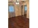 Bedroom with hardwood floors, ceiling fan, and closet with mirrored sliding doors at 1335 Cr 442, Lake Panasoffkee, FL 33538