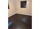Bedroom with hardwood floors and dark blinds at 1335 Cr 442, Lake Panasoffkee, FL 33538