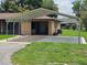 Spacious carport with concrete driveway and attached garage provides ample parking and protection from the elements at 1335 Cr 442, Lake Panasoffkee, FL 33538