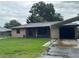Charming single-story home featuring carport, lush lawn, and inviting curb appeal at 1335 Cr 442, Lake Panasoffkee, FL 33538