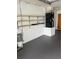 Spacious garage with storage shelves, painted floor, and new HVAC system at 1335 Cr 442, Lake Panasoffkee, FL 33538