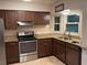 Kitchen featuring granite countertops, stainless appliances, and tile floors at 1335 Cr 442, Lake Panasoffkee, FL 33538