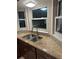Kitchen with stainless sink, granite countertops, and dark cabinets at 1335 Cr 442, Lake Panasoffkee, FL 33538