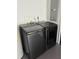 The laundry room features a new gray front-loading washer and dryer at 1335 Cr 442, Lake Panasoffkee, FL 33538