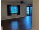 Open living room featuring dark wood flooring and abundant natural light at 1335 Cr 442, Lake Panasoffkee, FL 33538