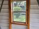 View from inside the shed looking out through the wooden window frame at 1335 Cr 442, Lake Panasoffkee, FL 33538