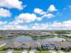 Aerial view of a residential community with multiple lakes, houses, and blue skies at 13461 Panama Beach Ct, Orlando, FL 32827