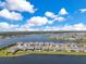 Beautiful aerial view of homes with lakefront property, featuring well-maintained lawns and a clear blue sky at 13461 Panama Beach Ct, Orlando, FL 32827