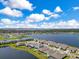 Aerial view of homes with lake views, swimming pools, and lush landscaping at 13461 Panama Beach Ct, Orlando, FL 32827