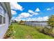 Backyard has a serene lake view and grassy lawn perfect for outdoor enjoyment at 13461 Panama Beach Ct, Orlando, FL 32827