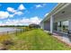 A house has a view of a pond and lush grass in its spacious backyard at 13461 Panama Beach Ct, Orlando, FL 32827