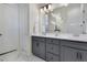 Bathroom featuring double sinks, grey cabinets, and marble floors at 13461 Panama Beach Ct, Orlando, FL 32827