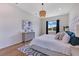Comfortable bedroom features a decorative rug, chandelier, and lots of natural light at 13461 Panama Beach Ct, Orlando, FL 32827