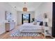 Comfortable bedroom features a decorative rug, chandelier, and lots of natural light at 13461 Panama Beach Ct, Orlando, FL 32827