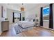 Comfortable bedroom features a decorative rug, chandelier, and lots of natural light at 13461 Panama Beach Ct, Orlando, FL 32827