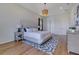 Bright bedroom with natural lighting, hard wood floors, and a tufted headboard at 13461 Panama Beach Ct, Orlando, FL 32827