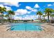 A community pool with a clear blue sky and lots of chairs to sit and relax at 13461 Panama Beach Ct, Orlando, FL 32827