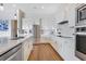 Contemporary kitchen featuring stainless appliances, white cabinetry, and quartz countertops at 13461 Panama Beach Ct, Orlando, FL 32827
