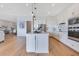 Spacious kitchen with stainless appliances, sleek island, and open layout to the living area at 13461 Panama Beach Ct, Orlando, FL 32827