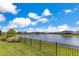 This home has a fantastic lake view with a lush green lawn at 13461 Panama Beach Ct, Orlando, FL 32827