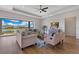 Cozy living room with a large window overlooking the lake, stylish furniture, and hardwood floors at 13461 Panama Beach Ct, Orlando, FL 32827