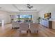 Bright living room with hardwood floors, ceiling fan, and large window offering water views at 13461 Panama Beach Ct, Orlando, FL 32827