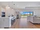 Open-concept kitchen and living space with island seating and scenic backyard views at 13461 Panama Beach Ct, Orlando, FL 32827