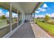 Covered patio with brick flooring, glass sliders, and an outdoor seating area with lake views at 13461 Panama Beach Ct, Orlando, FL 32827