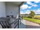 Inviting patio with stylish outdoor seating, overlooking a beautiful lake and manicured lawn at 13461 Panama Beach Ct, Orlando, FL 32827