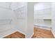 Bright walk-in closet featuring wire shelving, white walls and wood flooring at 13461 Panama Beach Ct, Orlando, FL 32827
