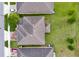 Aerial view of a well-maintained roof, green lawn, and neat landscaping at 144 Williamson Dr, Davenport, FL 33897